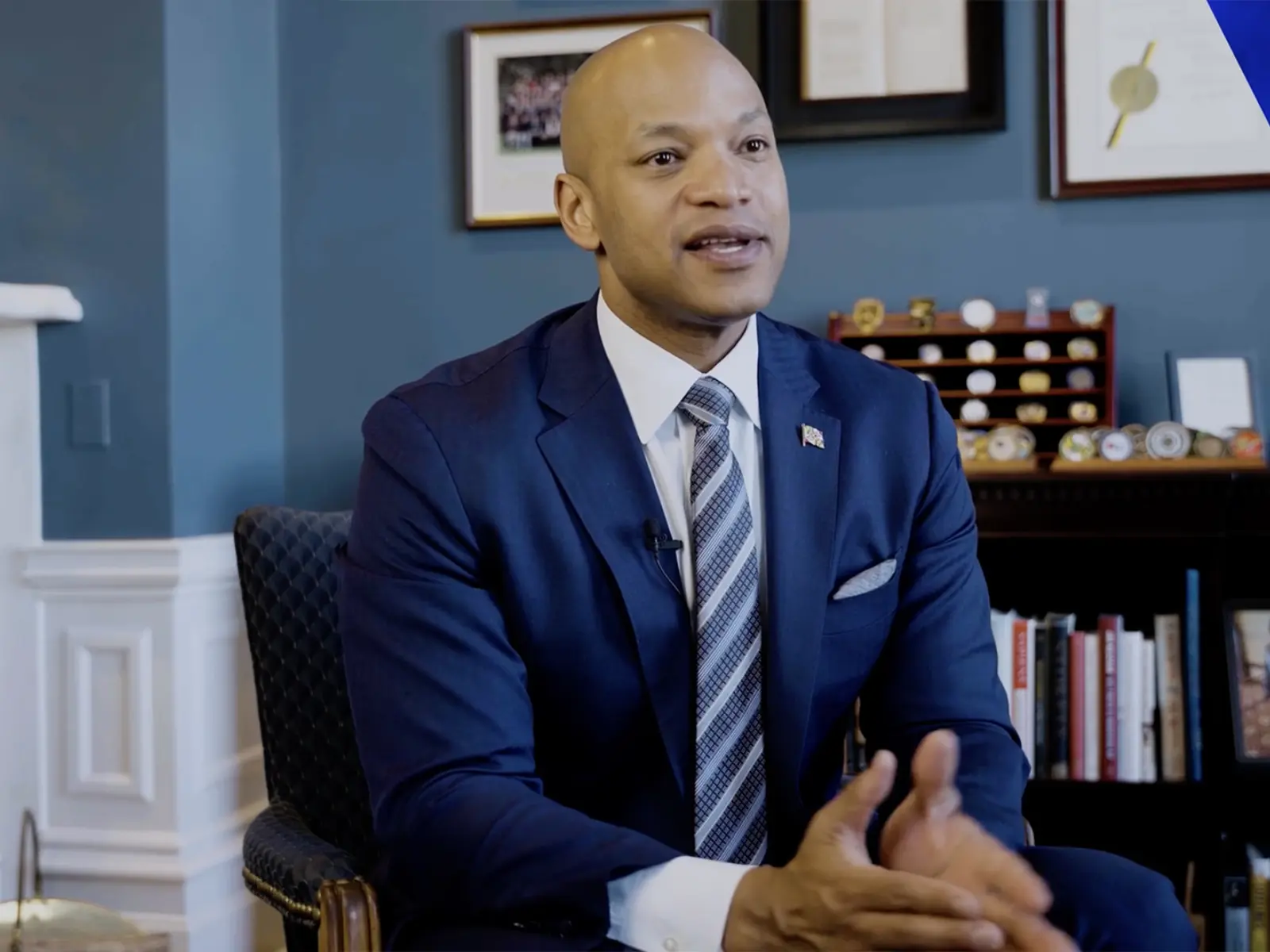Governor Wes Moore in a blue suit, sitting in a chair.