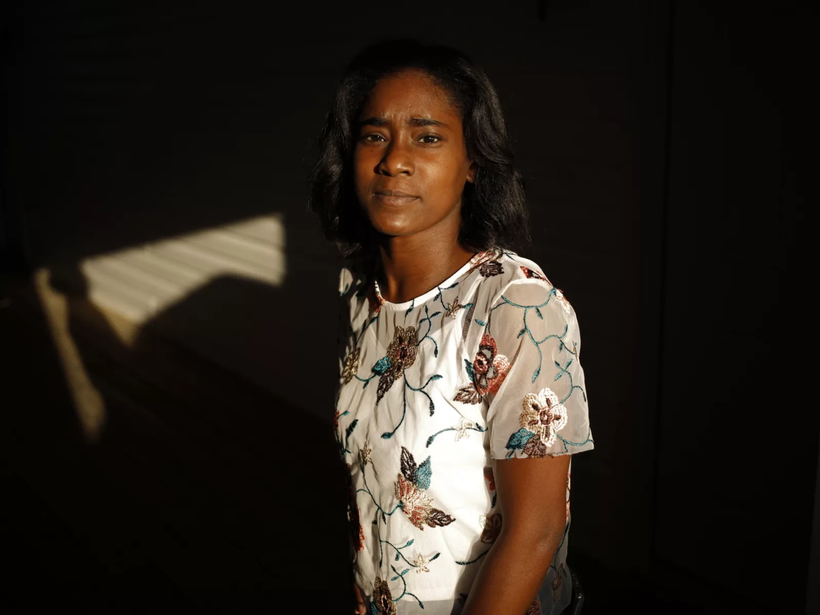 LaQuayia Goldring stands in front of a wall looking at the camera.